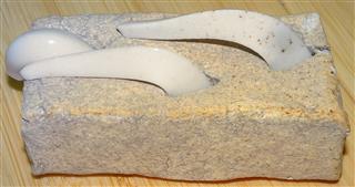 From the Thomas dump, handmade rectangle of clay with 3 tempature cones, all slumped.  The one handing over the edge has the tip broken off.  